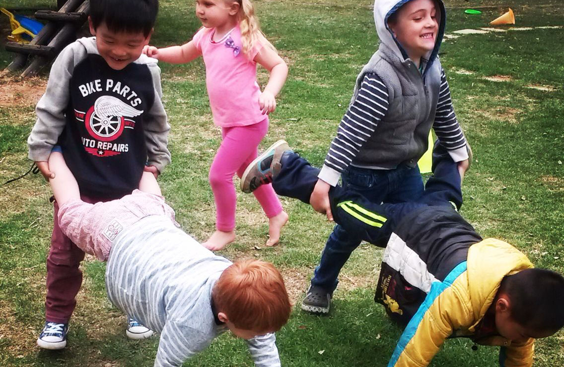 Children paying games outdoors.